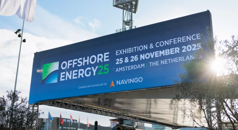 Large outdoor banner advertising Offshore Energy25, an exhibition and conference in Amsterdam, The Netherlands, on 25 & 26 November 2025. The banner includes logos and is displayed above an event area.