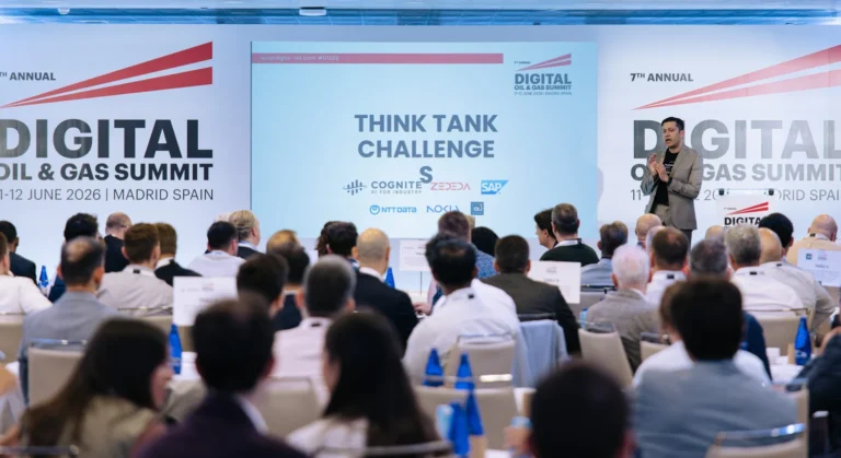 A speaker addresses a seated audience at the Digital Oil & Gas Summit in Madrid, with a presentation slide titled Think Tank Challenge displayed on a large screen behind him.